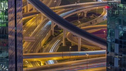 Aerial view from above to a busy road junction in Dubai night timelapse.