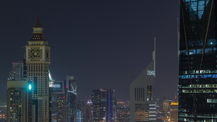 Fototapeta na wymiar Skyline view of the high-rise buildings on Sheikh Zayed Road in Dubai aerial night timelapse, UAE.