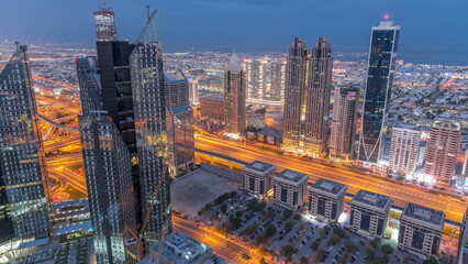 High-rise buildings on Sheikh Zayed Road in Dubai aerial night to day timelapse, UAE.
