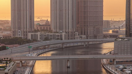 Fototapeta premium Walking promenade along water canal in Business Bay district of Dubai aerial timelapse.
