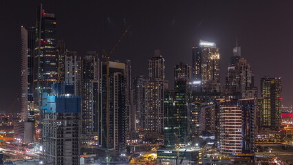 Fototapeta na wymiar Cityscape with skyscrapers of Dubai Business Bay and water canal aerial night timelapse.