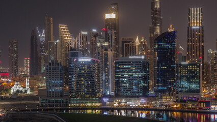 Fototapeta na wymiar Aerial view to Dubai Business Bay and Downtown with the various skyscrapers and towers night timelapse