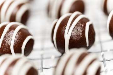 Making and decorating delicious homemade sweet balls with dark and white chocolate.