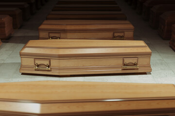 Mysterious warehouse with rows of wooden coffins. Closed casket. Burial.