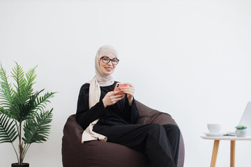Business person replying to email via phone in workspace