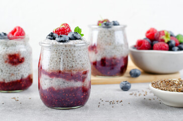 Healthy Chia Pudding in a Glass with Raspberry Jam and Fresh Berries