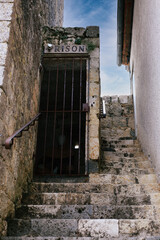 Incarcerated Man concept Despairs Alone in Medieval French Fortress Dungeon, Forgotten by Time,...