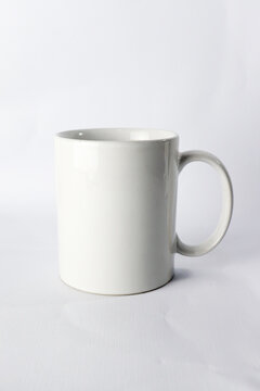 an empty ceramic white cup  isolated on white background.