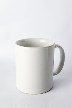 an empty ceramic white cup  isolated on white background.
