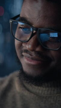 Vertical Screen: Close Up Portrait Of Successful Handsome Black Businessman Working on Laptop Late Night in Big City Office. Investment Manager Checking Financial Data from Project Management Report.