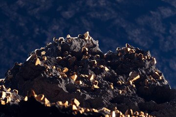Gold pieces in the rocks. A gold mine. Noble metal. Golden nuggets. Gold ore.