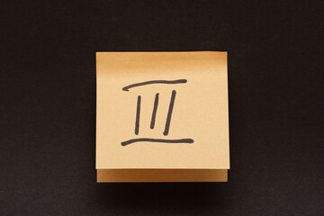 Roman numeral three, written in black marker on a self-adhesive sheet of paper.