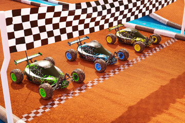 Three colourful RC-cars standing on a start line, ready for fast a toy race 4KHD