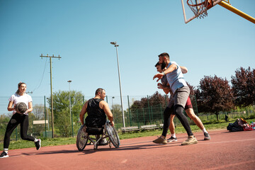 A physically challenged man in a wheelchair fearlessly engages in a spirited game of basketball...