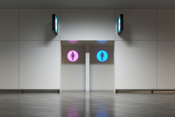 Airport terminal or train station lavatory entrance with glowing signs. Toilet