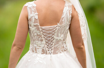 Wedding dress of a young bride rear view