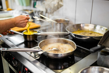 Chef cook hand cooking food at the restaurant kitchen