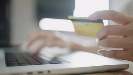 close up hand man using laptop computer with credit card e-commerce shopping online and making internet banking