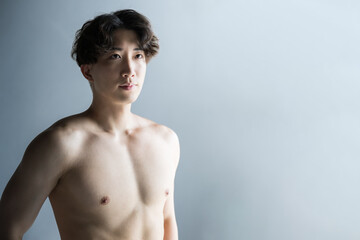 Young handsome man working out, upper body naked.