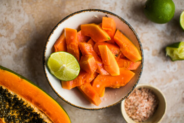 Papaya pieces with lime and salt on  plate cooking food