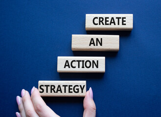 Create an action Strategy symbol. Wooden blocks with words Create an action Strategy. Beautiful deep blue background. Businessman hand. Business and Create an action Strategy concept. Copy space.