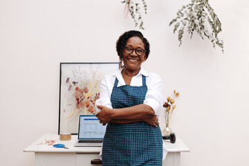 Happy flower shop owner smiling as she achieves success in her small business