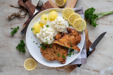 Breaded pork schnitzel with creamy cauliflower and potatoes. Traditional german cuisine
