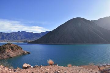 Beautiful landscapes of the Potrerillos Mendoza dam with its blue lake and the Andes mountain range.