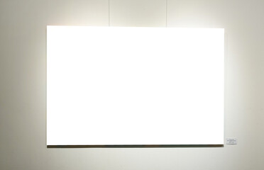 Blank picture frames on grey wall with glowing lamp, mock up