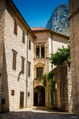 Fototapeta premium Beautiful old buildings on the cozy street of Kotor old town, Boka Kotor bay