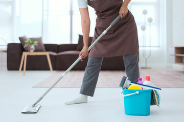 Maid using cleaner equipment in bucket plastic and mop to mopping and cleaning dust on the floor