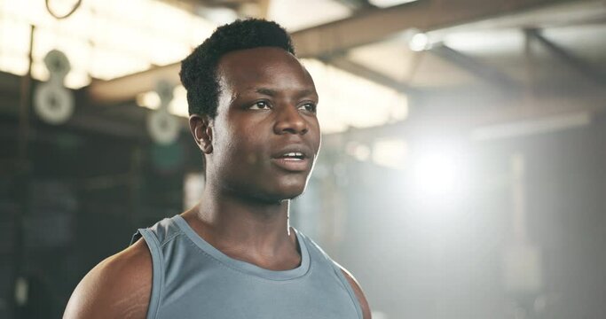 Black man at gym, water bottle and relax to hydrate in muscle development, strong body and fitness. Commitment, motivation and bodybuilder with drink in workout challenge for health and wellness.