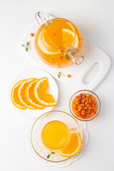 Sea buckthorn tea drink with oranges and mint. Autumn comfort hot drink. Herbal vitamin tea. 