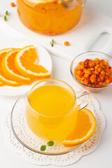 Sea buckthorn tea drink with oranges and mint. Autumn comfort hot drink. Herbal vitamin tea. 
