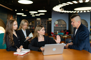 Woman poses question about design best practices to gain additional information. Male employee...