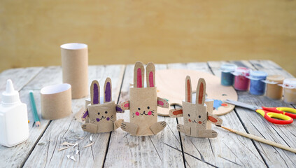 Kids craft bunnies out of recycling toilet paper roll, zero waste concept.