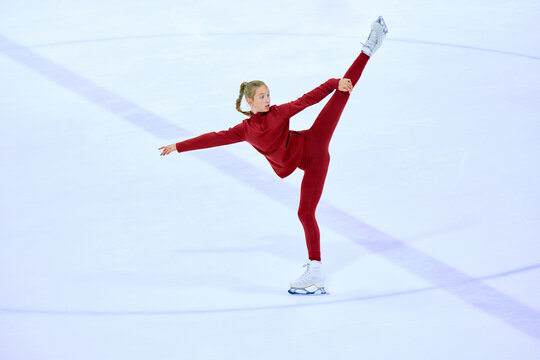 Talented, artistic and concentrated girl, figure skating athlete in motions, training on ice rink arena. Concept of professional sport, competition, sport school, health, hobby, ad