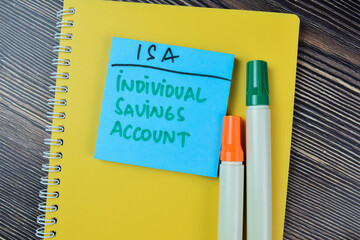 Concept of ISA - Individual Saving Account write on sticky notes isolated on Wooden Table.