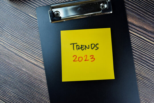 Concept of Trends 2023 write on sticky notes isolated on Wooden Table.