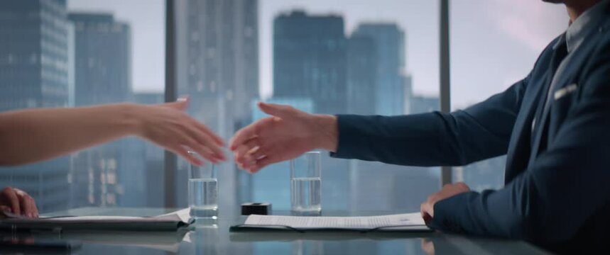 Close Up Of Female and Male Business Partners Sign Successful Deal and Shake Hands in Skyscraper Office. Corporate CEO and Investment Manager Handshake on Financial Opportunity. Anamorphic Shot