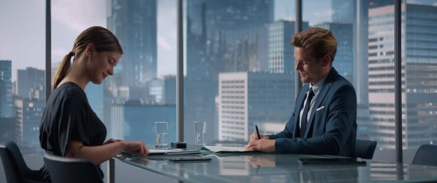 Female and Male Business Partners Sign Successful Deal, Shake Hands in Meeting Room in Skyscraper Office. Corporate CEO and International Supplier Handshake on Financial Opportunity. Anamorphic Shot