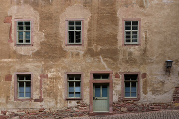 plaster facade wall of an old building with windows