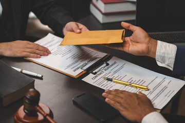 A businessman or politician together with a lawyer agrees to accept the bribe given in an envelope. illegal business Corruption in the contracting business Corruption and bribery concept