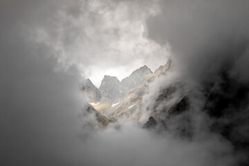 mountain peaks in dense clouds