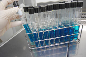 taking test tube with liquid, closeup. Laboratory analysis
