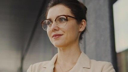 Attractive and proud woman teacher in eyeglasses looking at her students, loving her job, engaging in educational and outreach activities