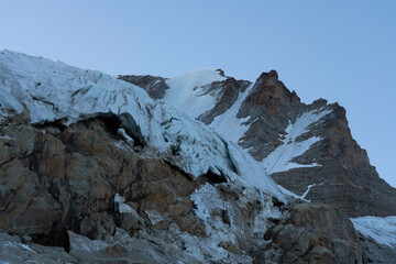 Gran Paradiso mountain peak and glacier view with crevasses detail and blue sky at blue hour....