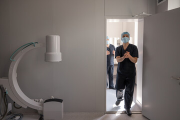 Surgeons preparing for the surgery, view from operating room