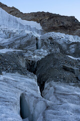 Glacier in the alpine mountains, crevasses and ice details. Gran Paradiso National Park mountaineering. global warming and climate change melting the ice.