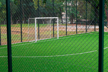 White football goal in an empty stadium. Soccer gate at the school stadium